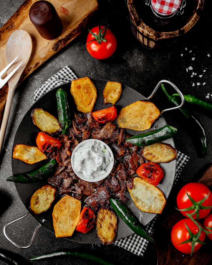 Foto gratuito vista superior de cordero saj kebab con tomate pimiento patata