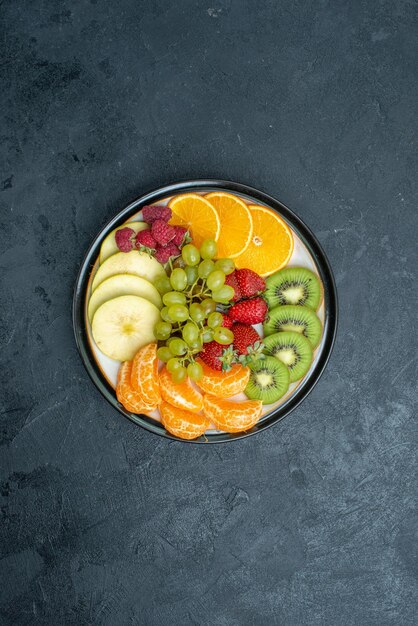 Vista superior de la deliciosa composición de frutas frescas en rodajas y frutas suaves en el fondo oscuro dieta de salud suave fresca madura