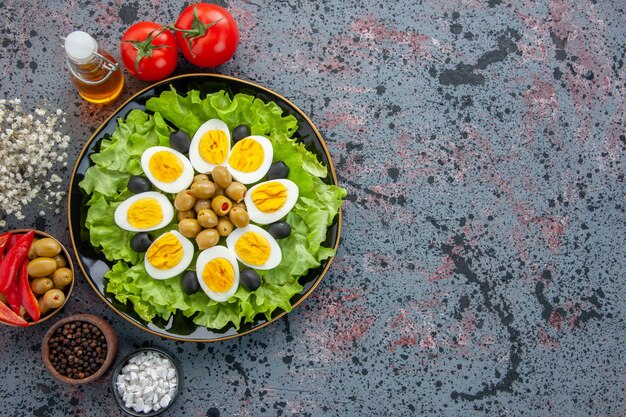 Vista superior deliciosa ensalada de huevo con tomates y aceitunas sobre fondo claro