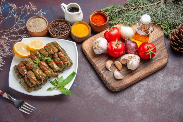 Vista superior de la deliciosa hoja dolma con verduras frescas y condimentos en el fondo oscuro comida plato hoja carne cena comida