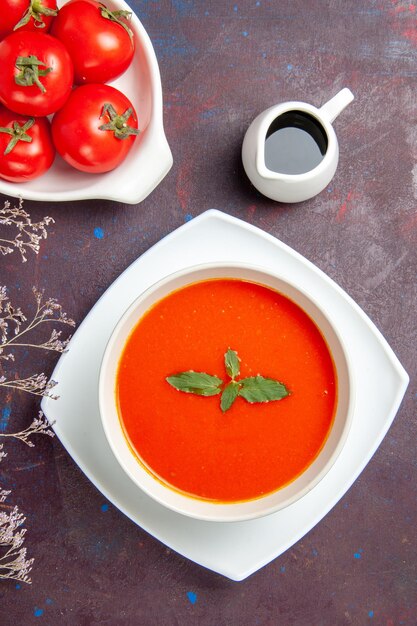 Vista superior deliciosa sopa de tomate con tomates frescos sobre fondo oscuro plato comida salsa tomate color sopa