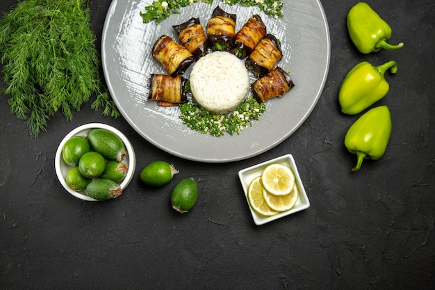 Vista superior deliciosas berenjenas cocidas con arroz en la superficie oscura cena comida aceite de cocina harina de arroz