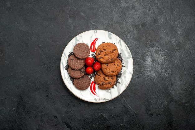 Vista superior deliciosas galletas de chocolate para té dentro de la placa