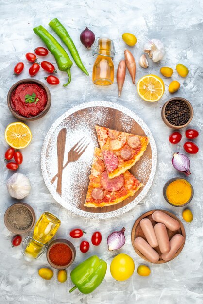 Vista superior de deliciosas rebanadas de pizza con verduras frescas en una mesa blanca