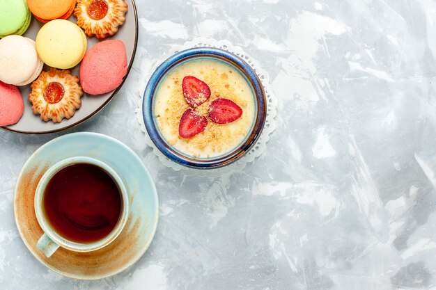 Vista superior delicioso postre cremoso con fresas frescas y té sobre fondo blanco claro postre helado sabor a fruta dulce