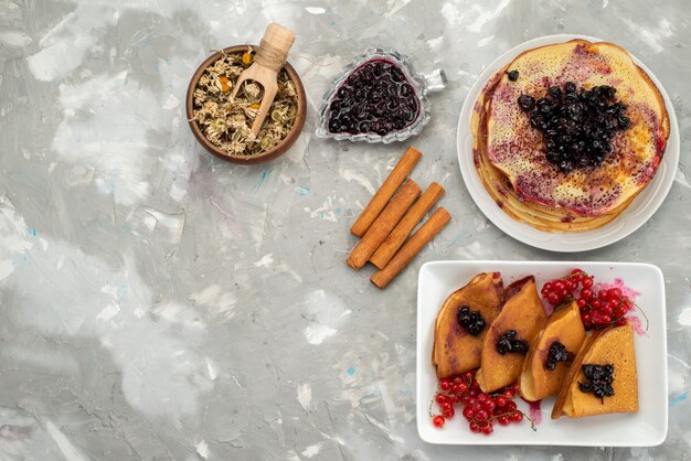 Una vista superior deliciosos panqueques deliciosos con jalea, arándanos, canela