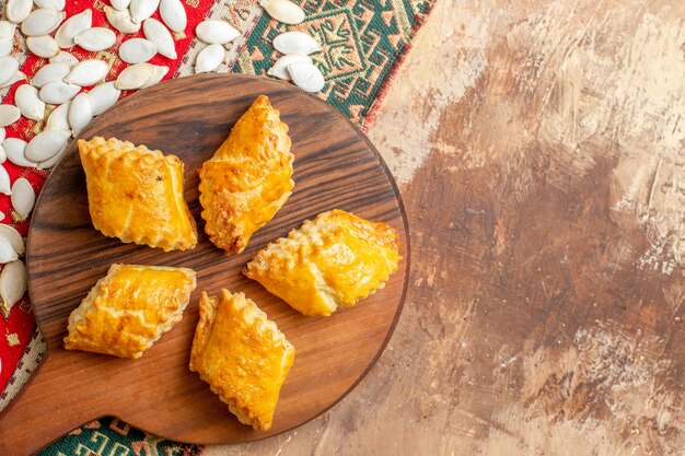 Vista superior de deliciosos pasteles de nueces con semillas sobre un fondo marrón