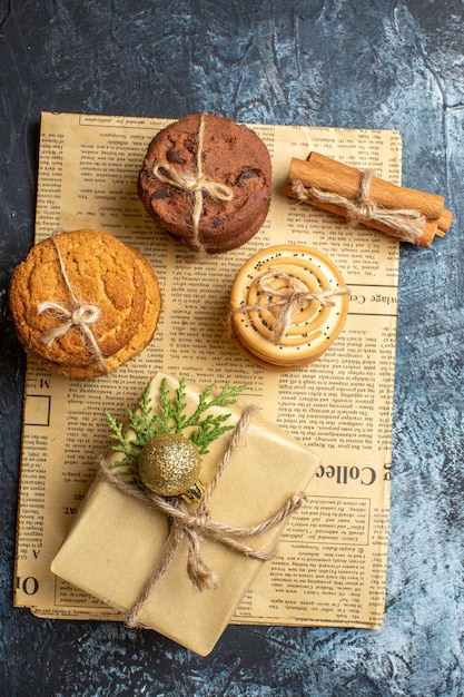 Vista superior diferentes deliciosas galletas con presente sobre fondo claro