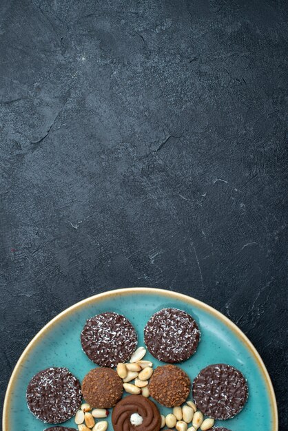 Vista superior de diferentes galletas de chocolate con nueces sobre fondo gris oscuro galleta de azúcar pastel dulce pastel de galleta