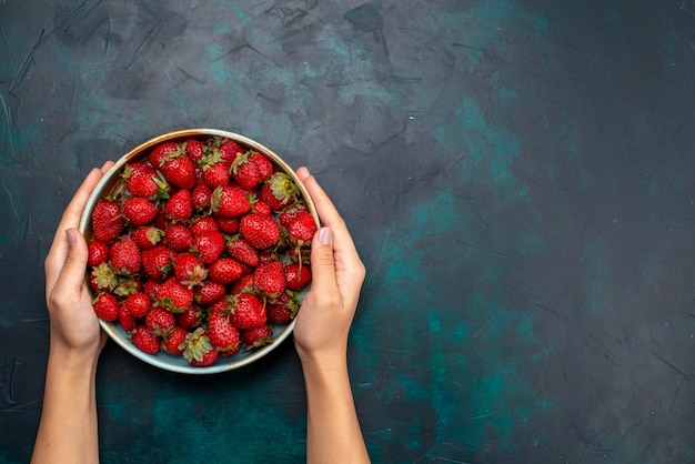 Vista superior fresas rojas frescas bayas agrias y suaves en el escritorio azul oscuro vitamina suave vitamina