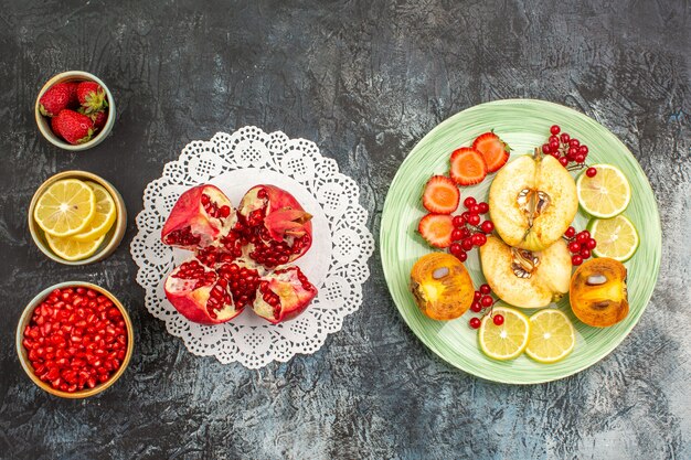 Vista superior de frutas frescas dentro de la placa en una mesa de luz frutas frescas muchas