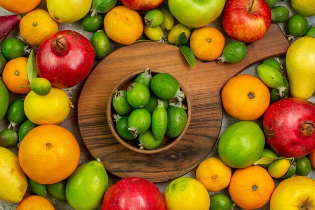 Vista superior de frutas frescas diferentes frutas maduras y suaves sobre un fondo blanco sabrosa foto color salud dieta baya