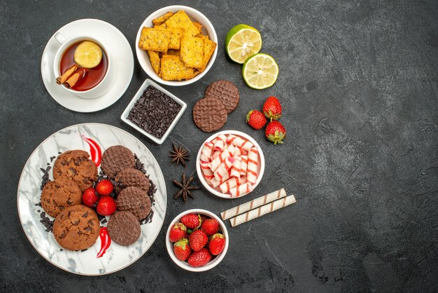 Vista superior de galletas de choco con dulces y té.