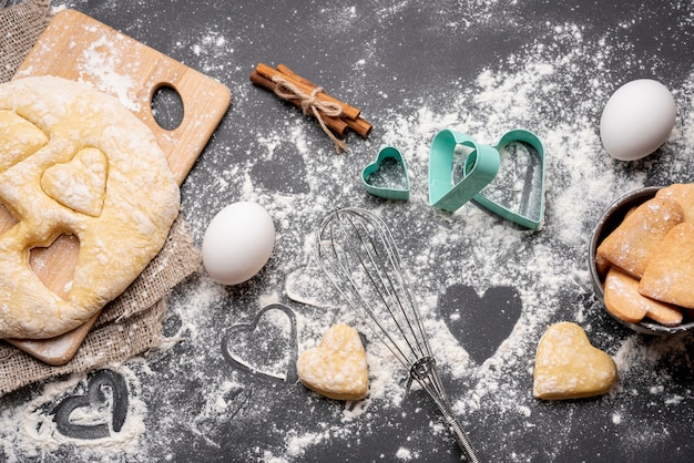 Foto gratuita vista superior de las galletas del día de san valentín con utensilios de cocina