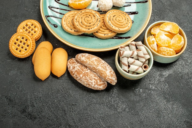 Vista superior de galletas dulces con caramelos de coco sobre fondo gris