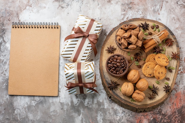 Vista superior de galletas dulces con regalos y nueces en la mesa de luz