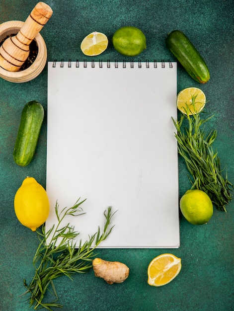 Foto gratuita vista superior de limones frescos con estragón de pepino en verde con espacio de copia