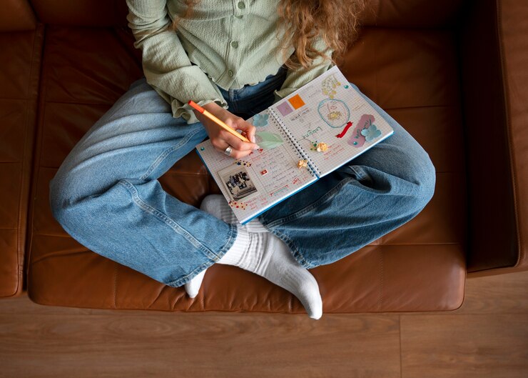 Foto gratuito vista superior mujer haciendo diario creativo