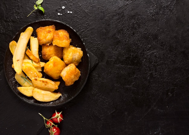 Vista superior de papas fritas en un tazón con espacio de copia y sal