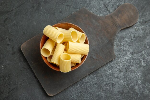 Vista superior de pasta italiana cruda poco formada en el escritorio gris masa de pasta de comida cruda