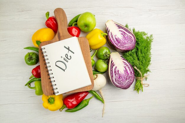 Vista superior de pimientos frescos con manzanas y repollo rojo sobre fondo blanco ensalada de dieta de vida saludable de color maduro