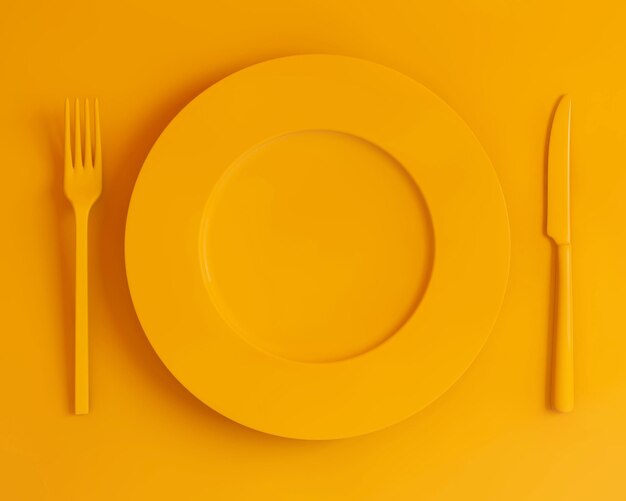 Vista superior placa amarilla tenedor y cuchillo sobre un fondo amarillo