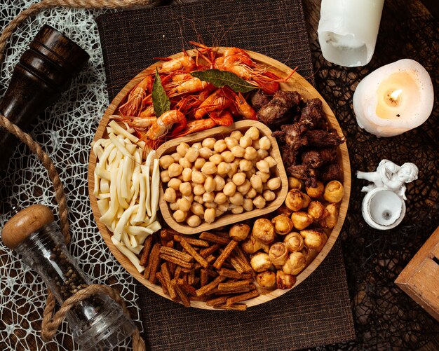 Vista superior de un plato de aperitivos de cerveza redonda con garbanzos de camarones y queso de cadena