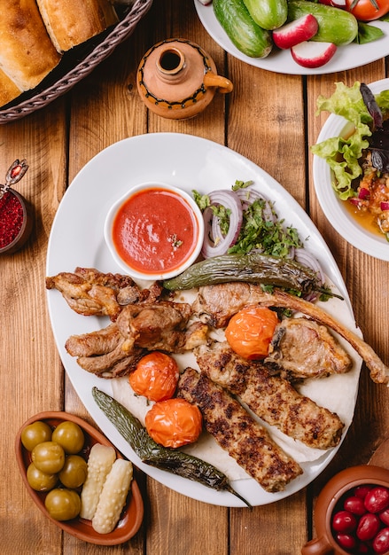 Foto gratuita vista superior de un plato de kebab con pollo con verduras, cordero tikka y lula kebabs