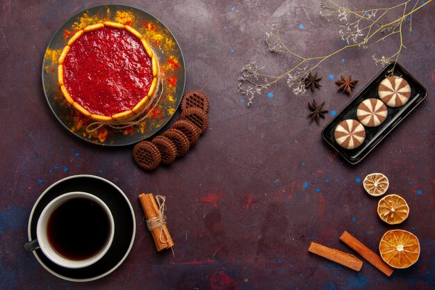 Vista superior de postre delicioso pastel con taza de café y galletas sobre fondo oscuro galletas de azúcar galleta pastel postre dulce