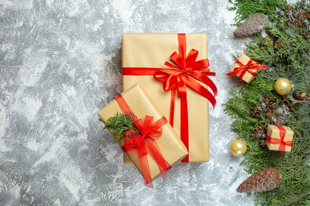 Vista superior de regalos de Navidad empaquetados con arcos rojos y árbol en blanco Navidad color regalo fotográfico de vacaciones año nuevo