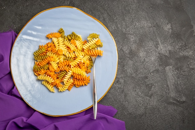 Vista superior sabrosa pasta italiana pasta espiral cocida inusual en gris