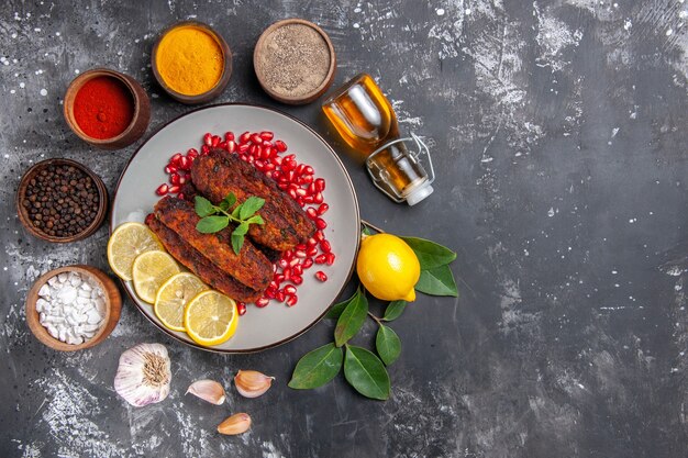 Vista superior sabrosas chuletas de carne con condimentos sobre fondo gris comida comida cena