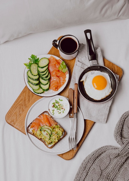 Vista superior de sándwiches de desayuno en la cama con tostadas y huevo frito