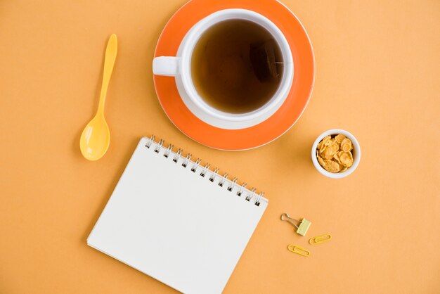 Vista superior taza de café con cuaderno