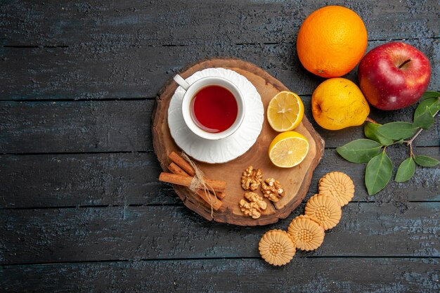 Vista superior de una taza de té con frutas y galletas