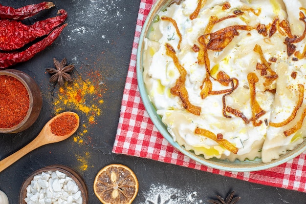 Vista superior de trozos de masa cocida con cebolla frita y diferentes ingredientes en el fondo oscuro cena comida aceite comida cocina foto plato