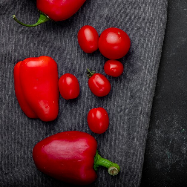 Vista superior de verduras como tomate pimiento sobre superficie de tela gris