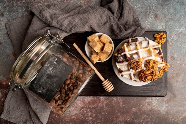 Vista superior de waffles apilados en un plato con nueces y terrones de azúcar