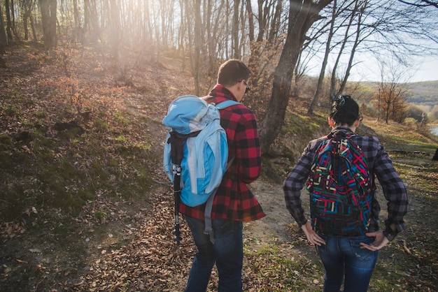 Foto gratuita vista trasera de excursionistas con mochilas caminando