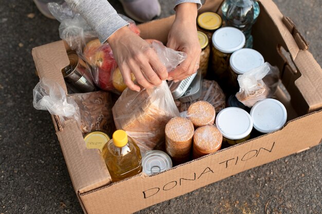 Voluntariado y comida en caja de cerca.