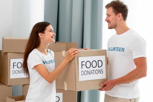 Voluntarios manipulando cajas con donaciones de alimentos.