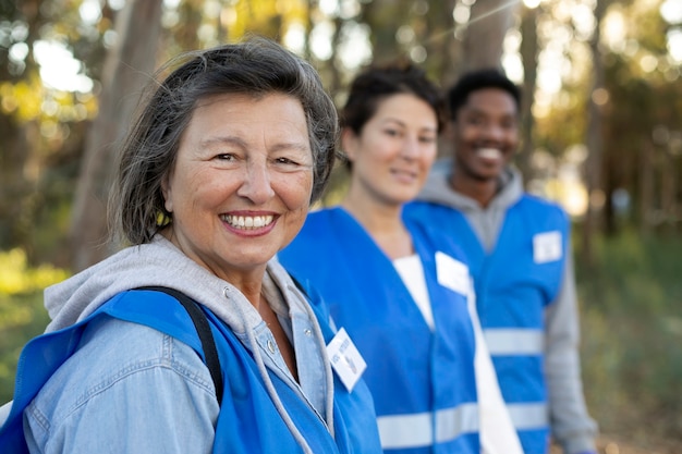 Voluntarios sonrientes de tiro medio al aire libre