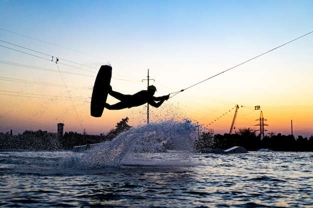 Foto gratuita wakeboard wakeboard saltando al atardecer