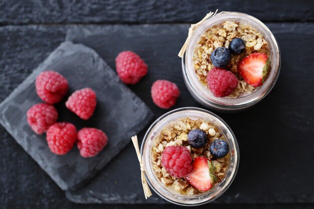 Yogurt con avena y bayas en vasos