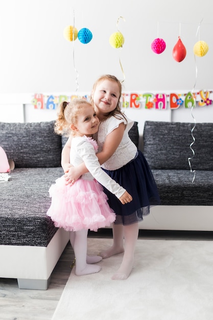 Abbracciare le ragazze alla festa di compleanno