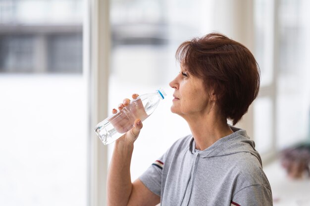 Acqua potabile della donna del colpo medio