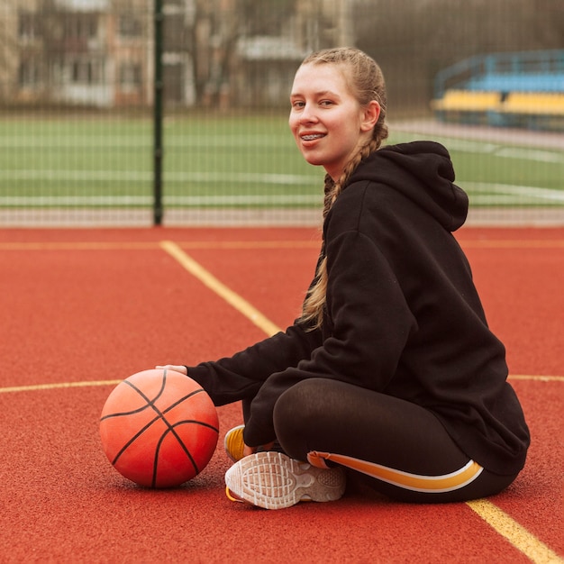 Adolescente in posa al campo da basket