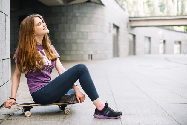 Adolescente sorridente sullo skateboard