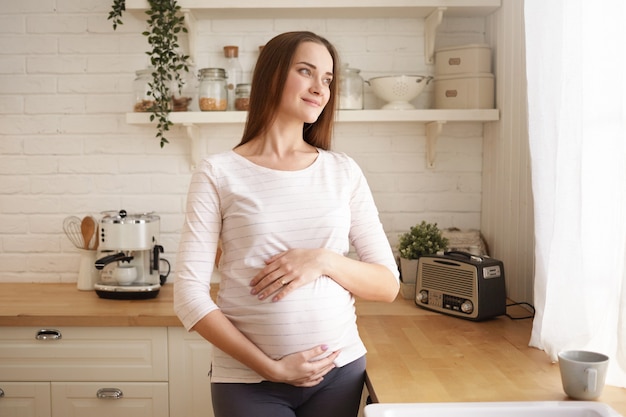 Adorabile carino giovane donna incinta in posa