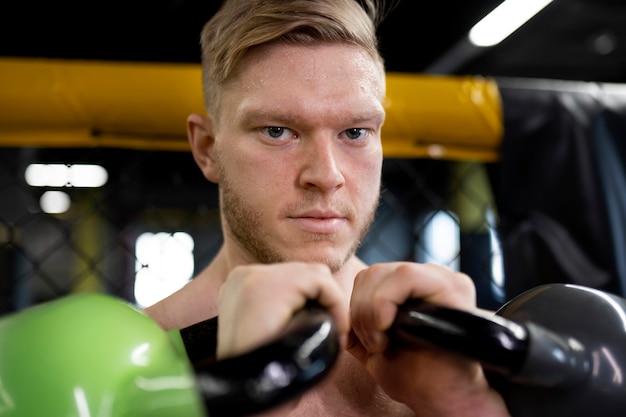 Allenamento uomo sorridente con kettlebell